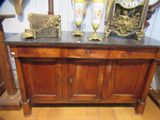 une armoire en bois avec un plateau en marbre sur lequel est posée une horloge
