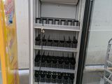 a refrigerator that has many bottles of soda in it