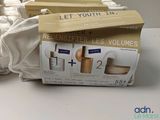 packaging of a set of three bottles and a cloth on a table