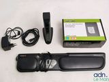a remote control and a charger on a table