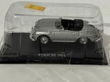 a toy car in a clear case on a white surface