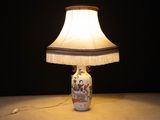 a lamp that is sitting on a table with a lamp shade on it