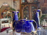 three blue vases sitting on a table in a room
