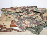 a camouflage jacket and a pair of binoculars sitting on the floor