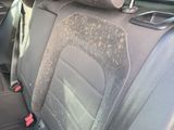 a dirty seat in the back of a car