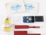 a picture of the contents of a men ' s grooming kit including a brush, comb, razor, razor blade, soap, and razor