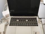 a laptop computer sitting on top of a white desk