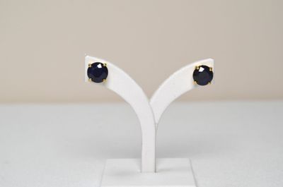 a pair of black and white earrings on a white stand