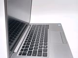 a silver laptop computer sitting on top of a white table
