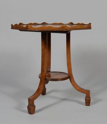an old wooden table with a curved top and a curved base