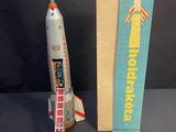 a toy rocket that is next to a book