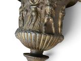 a large vase with a statue on it on the wall
