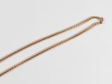 gold plated necklace with a heart pendant and a chain on a white background