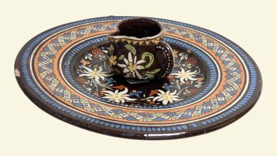 a small cup and saucer sitting on a plate