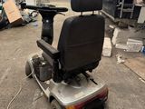 a scooter that is sitting in the middle of a warehouse