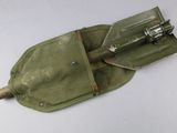 a small tool in a green pouch on a white surface