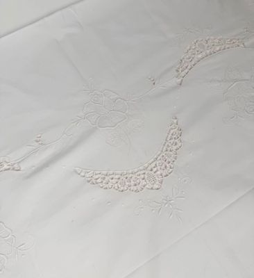 a white bed with a white comforter and a white comforter