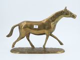 bronze figurine of a running horse on a white background