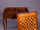 an old wooden desk with a chess board on top of it