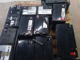 many different types of batteries sitting on a pallet