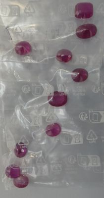 a plastic bag with a bunch of red beads in it