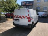 a white van that is parked in front of a building