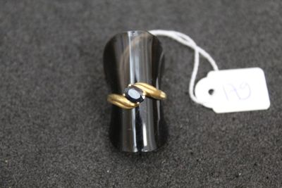 a ring with a diamond on it sitting on a table next to a price tag