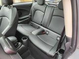 the back seats of a car with a cup holder in the center