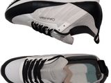 two pairs of white and black sneakers with black laces