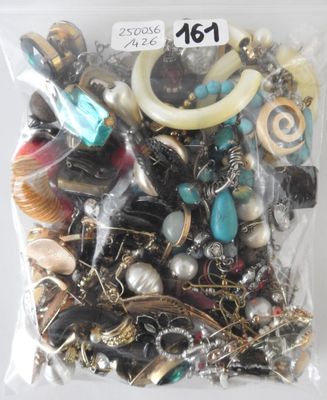 a bag of assorted jewelry on a white surface
