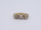 a three stone ring with three diamonds on a white background