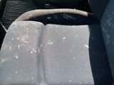 a dirty seat in the back of a truck