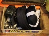a box with a chainsaw and a belt in it
