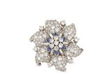 a close up of a diamond and sapphire flower broochle