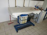 a table with a mattress on it in a room