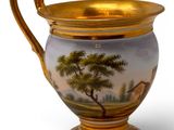 a vase with a painting on it sitting on a table