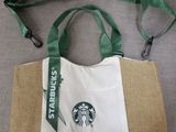 a bag with a starbucks logo on it sitting on a couch