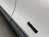 a remote control attached to the side of a white car
