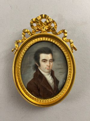 portrait of a man in a brown coat in a gold frame