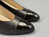pair of black leather shoes with pointed toe on white surface