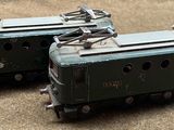 two toy trains sitting on the ground next to each other