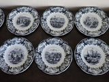 six blue and white plates with a picture of a man and a woman on them