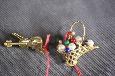 pair of gold tone christmas ornaments with red string and bells