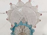 a glass vase with a flower inside of it on a table