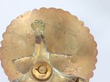 a gold plate with a flower on top of it