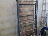 a picture of a room with a ladder and a blue chair