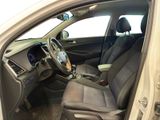 the interior of a car with the door open and the driver ' s seat down