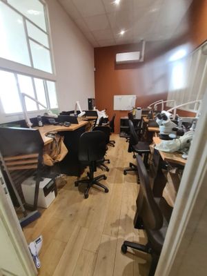 a room with a lot of desks and chairs in it