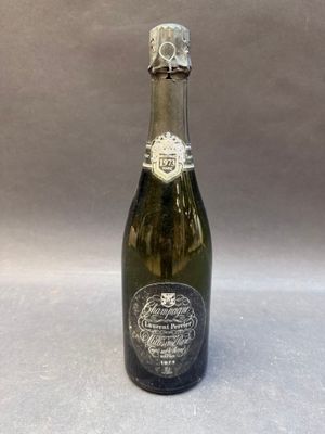 an old bottle of champagne sitting on top of a table