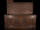 a wooden chest with carvings on the sides of it